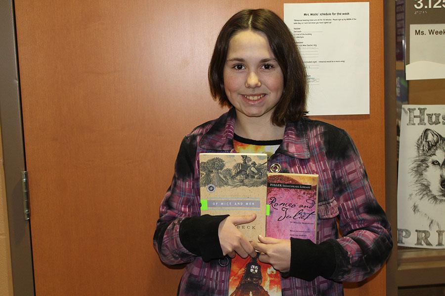 Smiling from ear to ear, freshman Charlotte Zimmer holds up two of PN's required reads. Take a look at which books are the most popular.