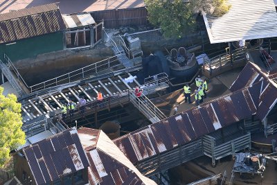 Investigators examine the wreckage at Dreamworld after the accident.