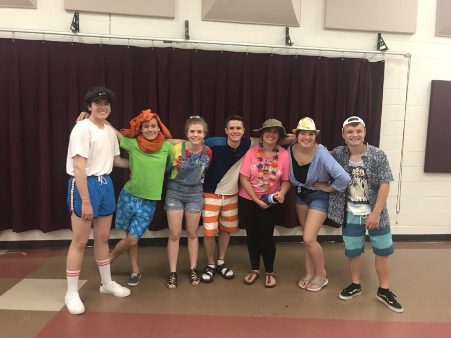 Pictured left to right, senior Isaac Reid, sophomore Charlie Marsh, junior Sydney Dudley, senior Elliot Hoinville, sophomore Maren Case, sophomore Ellie Mancina, and senior Ryan Daniel, all pose together, dressed in the theme of the night, summer wear. All photos by Kylie Clifton