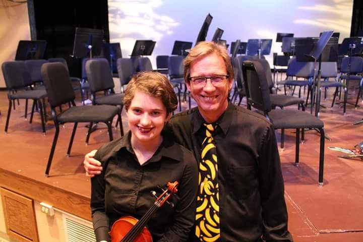 Dodge poses with Hazen after the spring concert, which was the last concert that he directed for the high school. “I had a bunch of mixed emotions; I was happy, but at the same time I was really sad that my favorite teacher was going to be gone...but he deserves a good retirement,” she said. 
