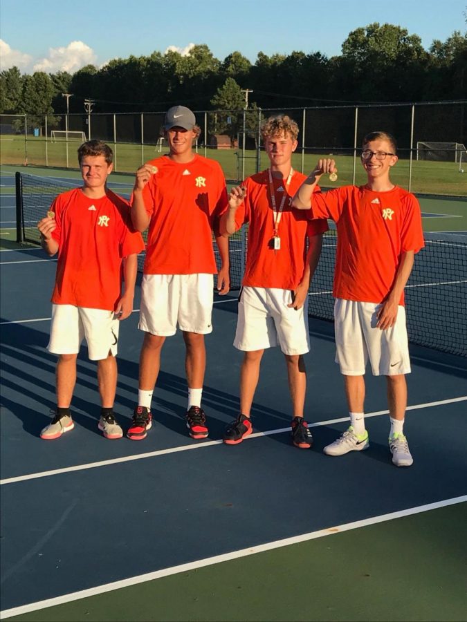 Alex+Wootton%2C+Jackson+Graham%2C+Graham+Holley+and+Keegan+Bach+celebrate+with+their+medals+after+winning+their+flights+at+the+Greater+Kalamazoo+tournament.+This+was+the+first+time+in+history+that+Northern+swept+singles.