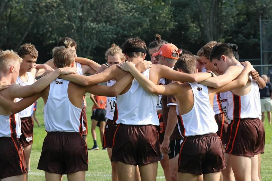 The mens team comes together for a pep talk before running at St. Joe. 