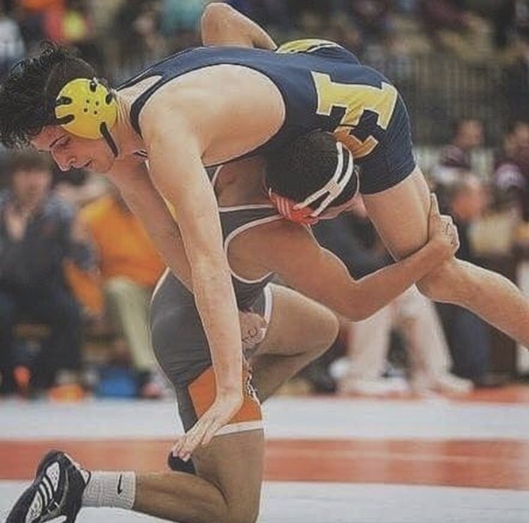Mitchell Derhammer, pictured in the orange and gray Huskies wrestling uniform, has been one of the team’s most hardworking wrestlers. He is shown competing in individual and group competitions. 
