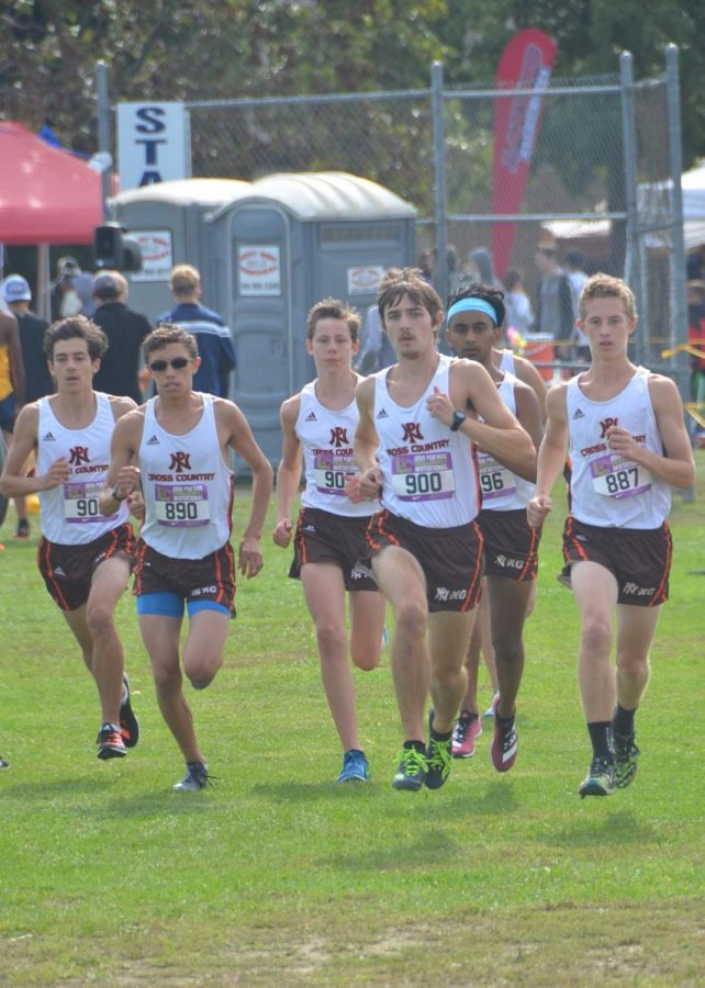 The boy’s varsity team (L to R: Ryan McCune, Drew Gonzalez, Logan Post, Matt Schieber, Kanishk Madhav, Dylan Butler) warms up for their 2:00 pm race. “The Portage Invite is the king of XC races, it is what you think about when you start the season,” says freshman Logan Post. “I felt good PRing in the race because it makes you feel that even though there were hundreds of good runners, you beat them, pushed through them.”