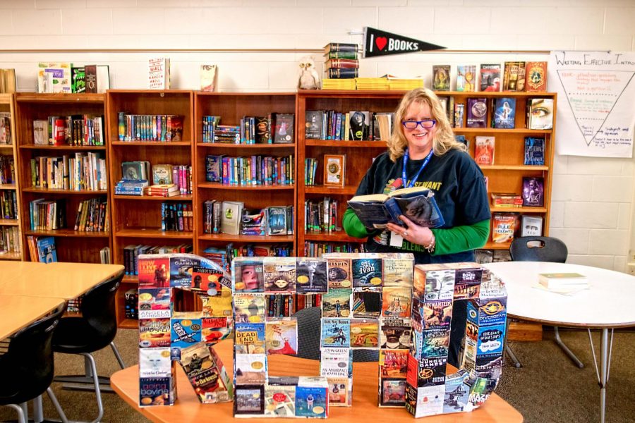 English teacher Sarah Miller at home in her classroom, which is full of books. 