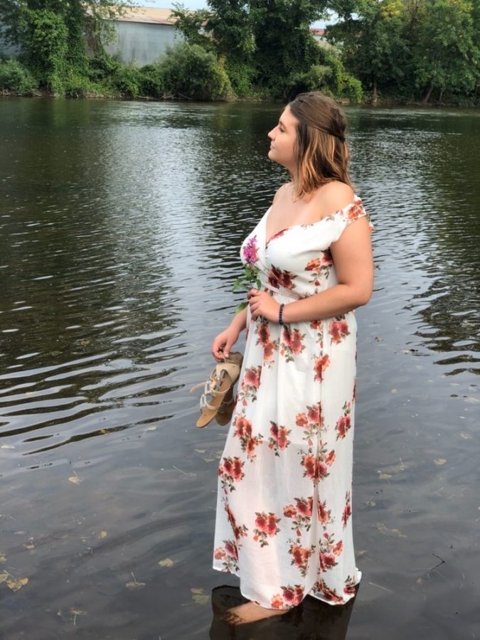 Lockwood poses in the lake for her senior pictures at Scidmore Park, of Three Rivers. Holding her shoes and looking towards the future.
