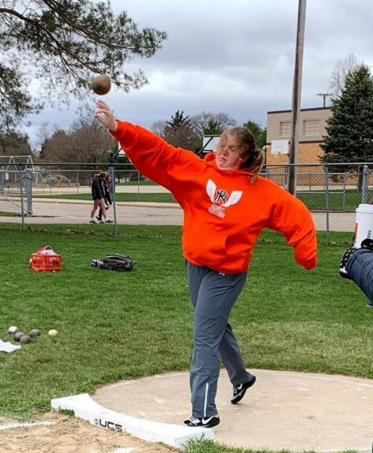 Sophomore Charlotte Wilson throws a shot-put at an outdoor meet. She looks up to other women in this male-dominated sport: The women throwing records are really trailblazers, she says. Photo courtesy of Charlotte Wilson.