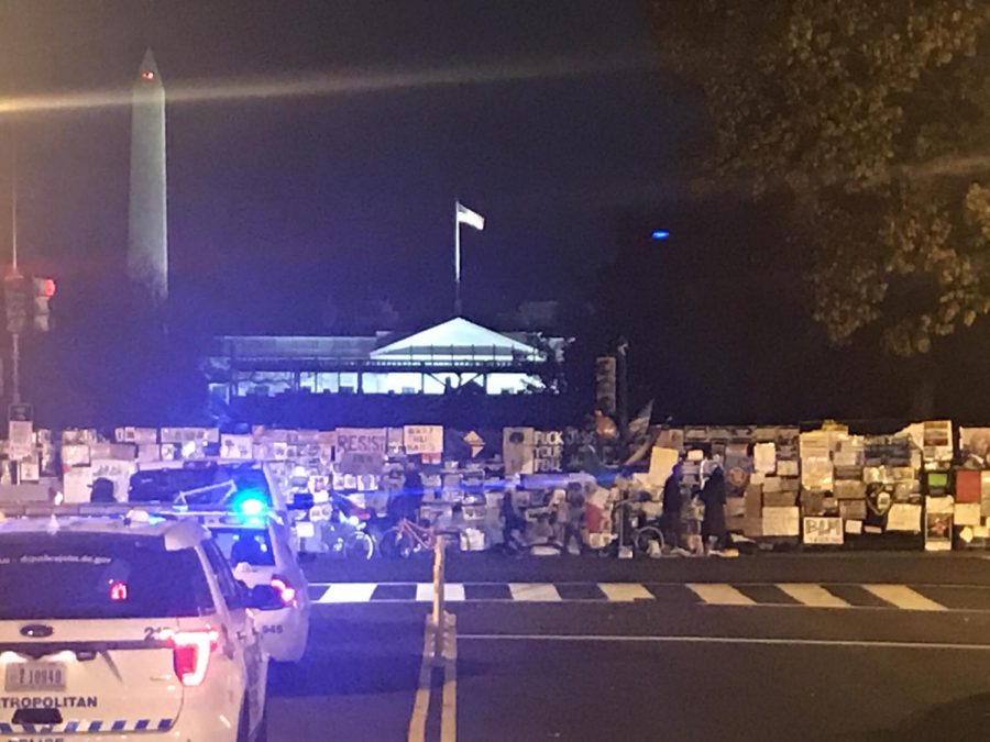 The White House is visible here illuminated beyond the Black Lives Matter signs. 