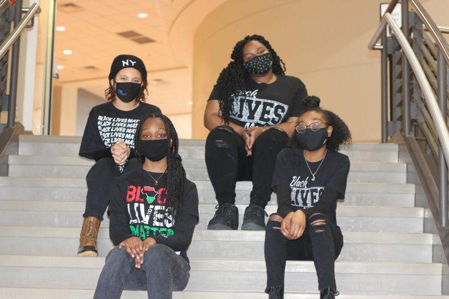 BHM leaders L to R: back row: Maya Daniels, Makayla Bolton, front row: Alanna Harris, Jamillah Clark wrap up filming the assembly on the stairs leading to the lower level commons. 
