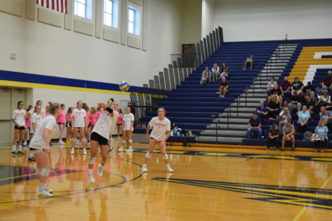 Senior Lyse Bates digs a ball from the back row. As a libero, she often sets up the plays. 