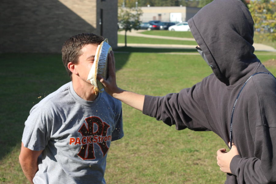 History teacher and Senate adviser Joey Wood gets pied by sophomore Kamden Morgan as a part of the Lunches for Lives fundraiser. 