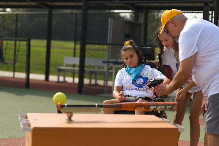 PN counselor Amy DiMaggio's daughter, Ruby, bats at the new Southwest Michigan Miracle League field. 