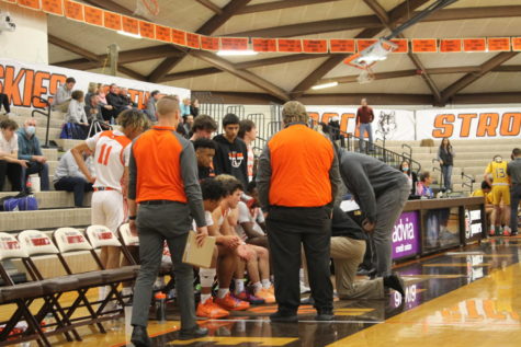 Players meet with coach to talk game strategy during a time out. 