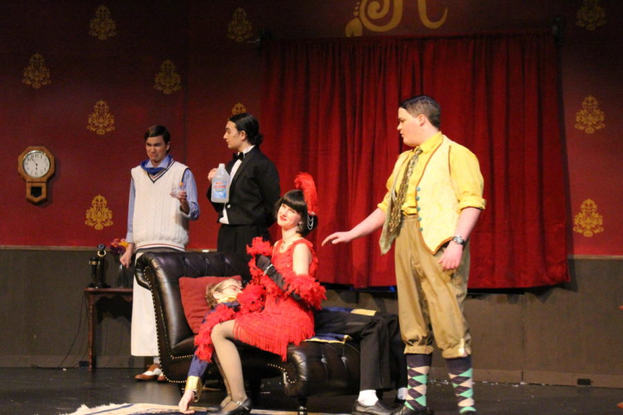 Thomas Colleymore (in the yellow) comforts Florence Collymore (in the red) while Perkins gives Cecil Haversham, played by Elijah Parker, a cleaning agent to drink instead of water. 