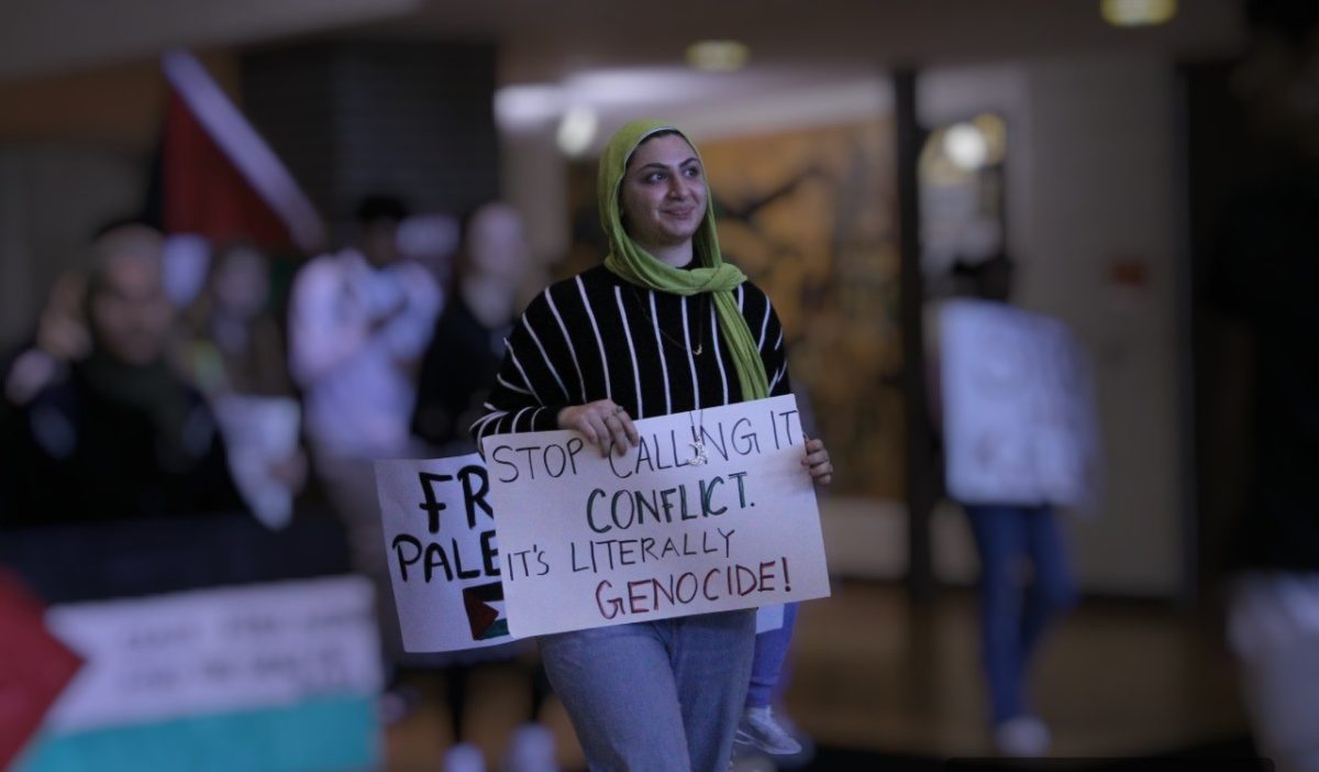  Sophomore Maya Abdulhak proudly marches with her homemade, passionately-worded sign. “Whats really been hitting me for the past few days is that Palestinians, Palestinian children, and Palestinian adults have been dying in huge numbers,” she said. “They’re human and they’re dying and that should be enough to pull on anybody’s heart strings.” 
