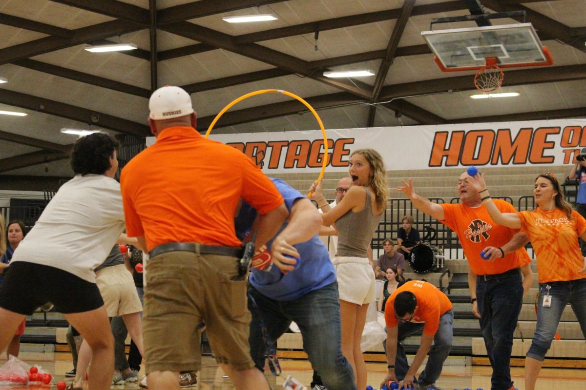 Math teacher Patrick Greeley fends off an attack from a rival department to help his team during the game. 